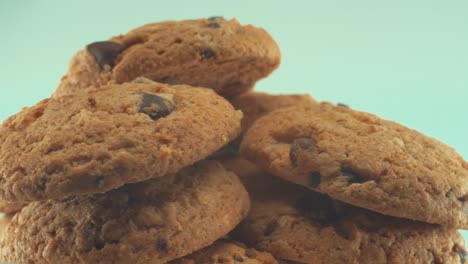 a macro close up shot of a white plate full of tasty chocolate chip cookies, on a 360 rotating stand, studio lighting, slow motion, 4k video