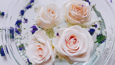 delicate floating roses in glass bowl