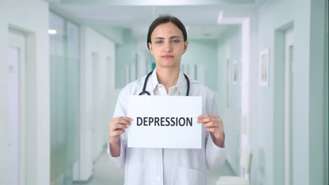 sad indian female doctor holding depression banner