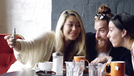 friends taking selfie photograph self portrait in cafe