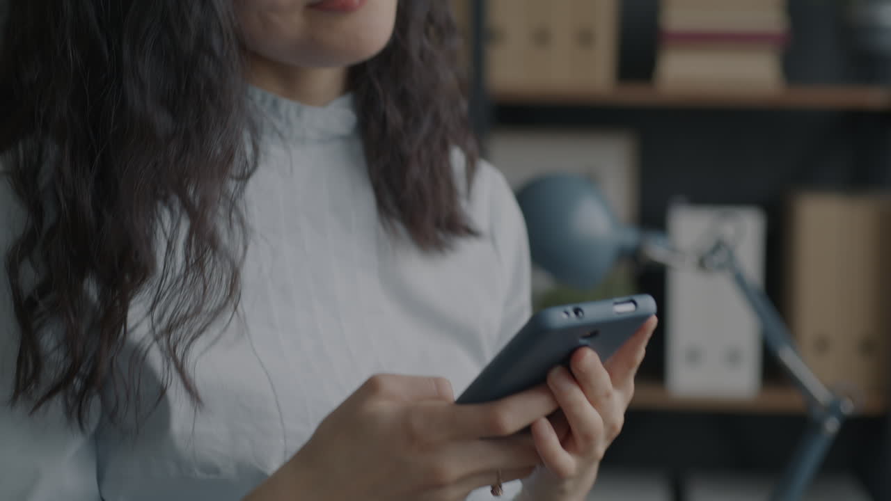 mujer de negocios que usa un teléfono inteligente en la oficina