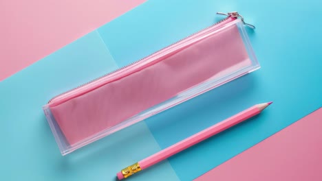 pink pencil and pouch on pink and blue background