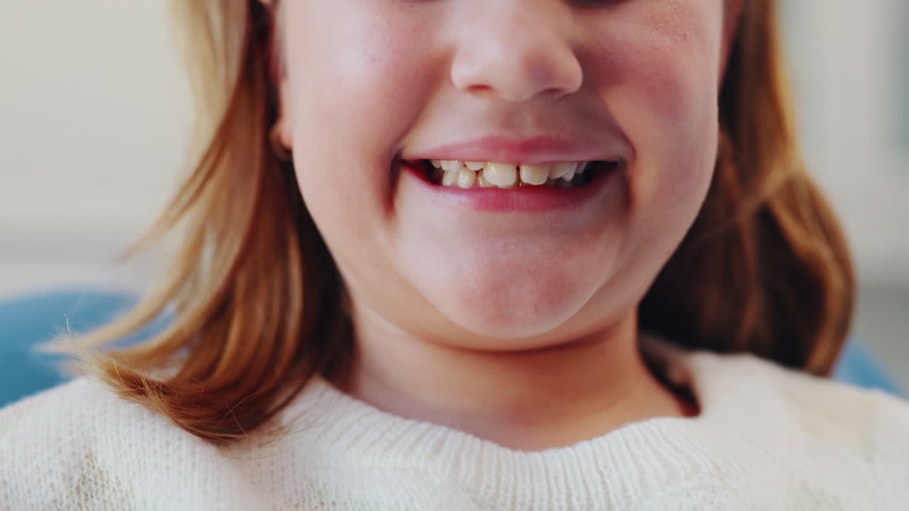 Close-up of a smiling young girl's teeth