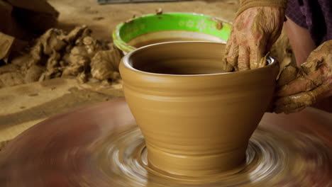 Close-up-footage-of-Thanh-Ha-artisans-making-pottery-on-a-foot-powered-turning-table,-showcasing-the-ancient-technique-of-turning-clay-into-beautiful-artwork