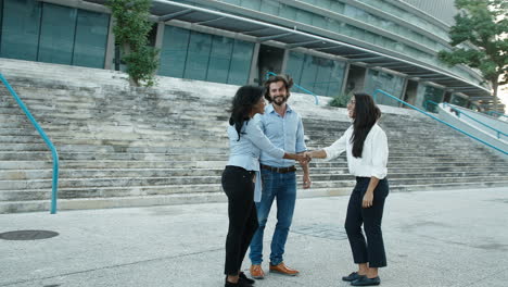 three people shaking hands outside after important job interview