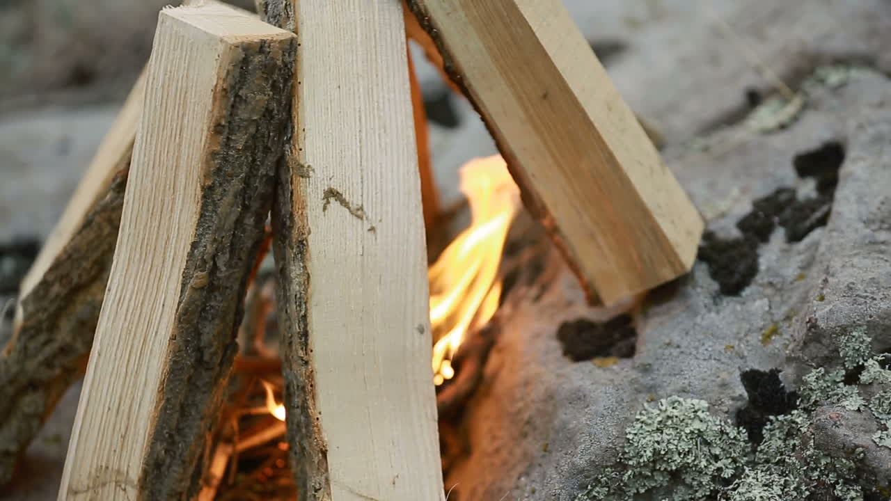 Making Camp Fire In Nature. Young man who making a camp fire in nature