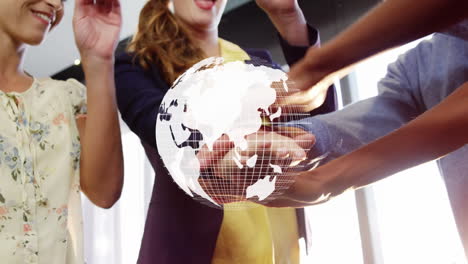 animation of globe over work colleagues stacking hands in background