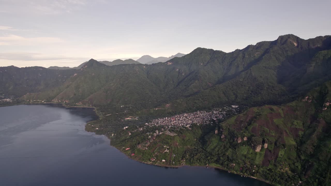A stunning aerial view captures the vibrant town of San Pedro La Laguna on the shores of Lake Atitlán at sunrise