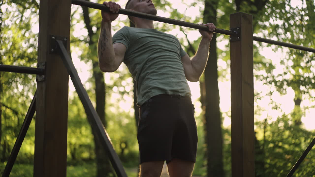 Man doing pull-ups in the park