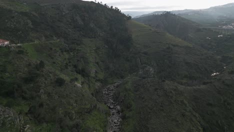 Lamego's-River-Tributary-Amidst-Hills,-Portugal---aerial