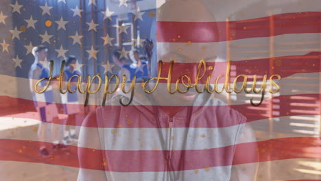 animation of happy holidays text and diverse basketball players with coach over flag of usa