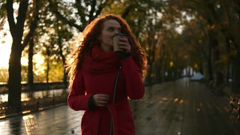 red haired woman walking on a city park