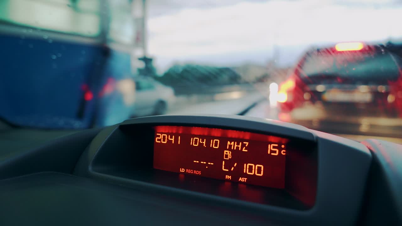 Driving a car in traffic jam in bad weather conditions. Car dashboard. Close-up