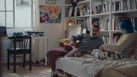gen z couple chilling on couch and talking at home
