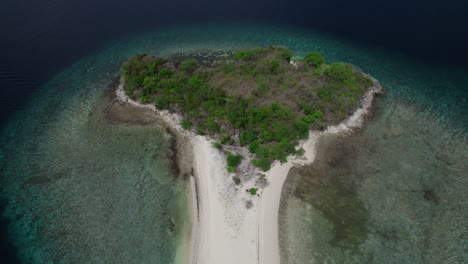 breathtaking aerial view of a small island surrounded by turquoise waters near el nido, palawan, philippines.