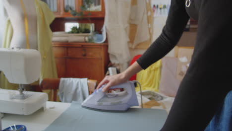 woman ironing fabric for sewing