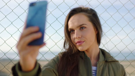 A-happy-young-woman-taking-selfies-on-her-mobile