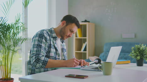 man working and writing