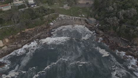 Boats-Docked-At-Gordon's-Bay-NSW---Secluded-Beach-In-Sydney,-Australia---drone-pullback