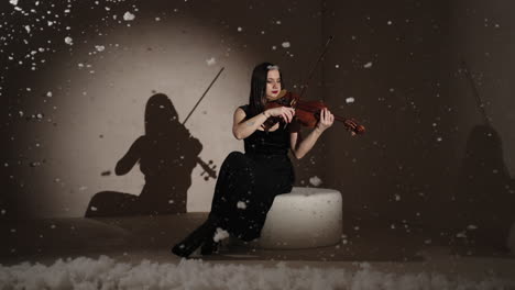 woman playing violin in winter studio setting