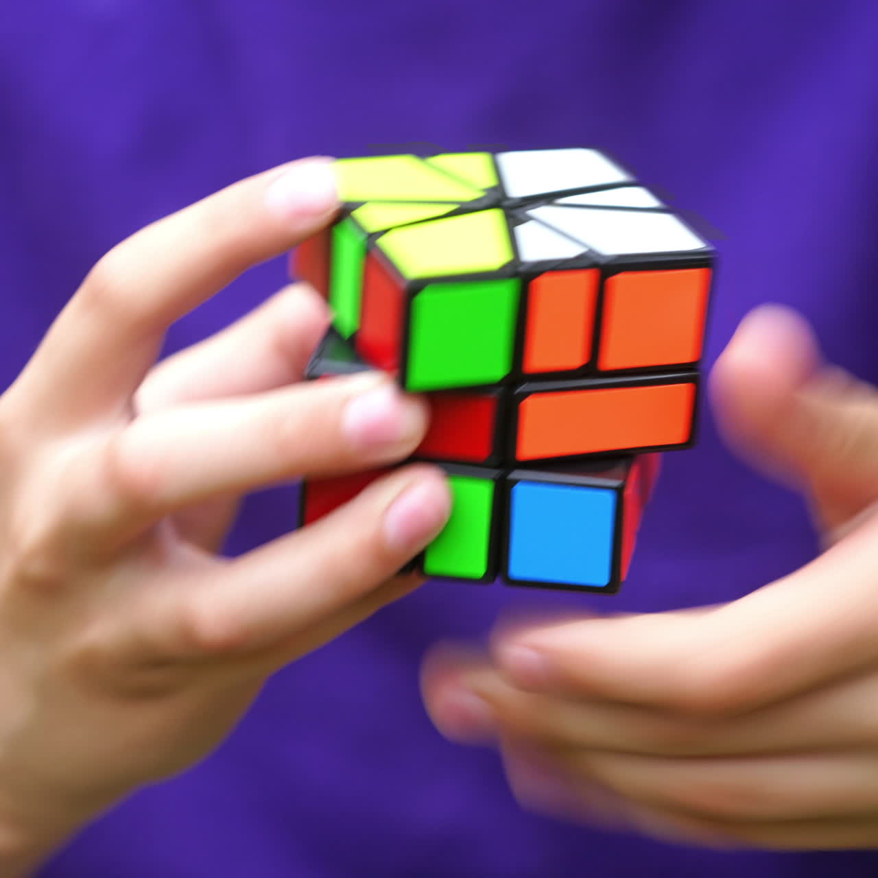 Illustrative video of solving Rubik's cube. Smart teenager solves puzzle game with colorful cube to the end. Rubik's cube in boy's hands.
