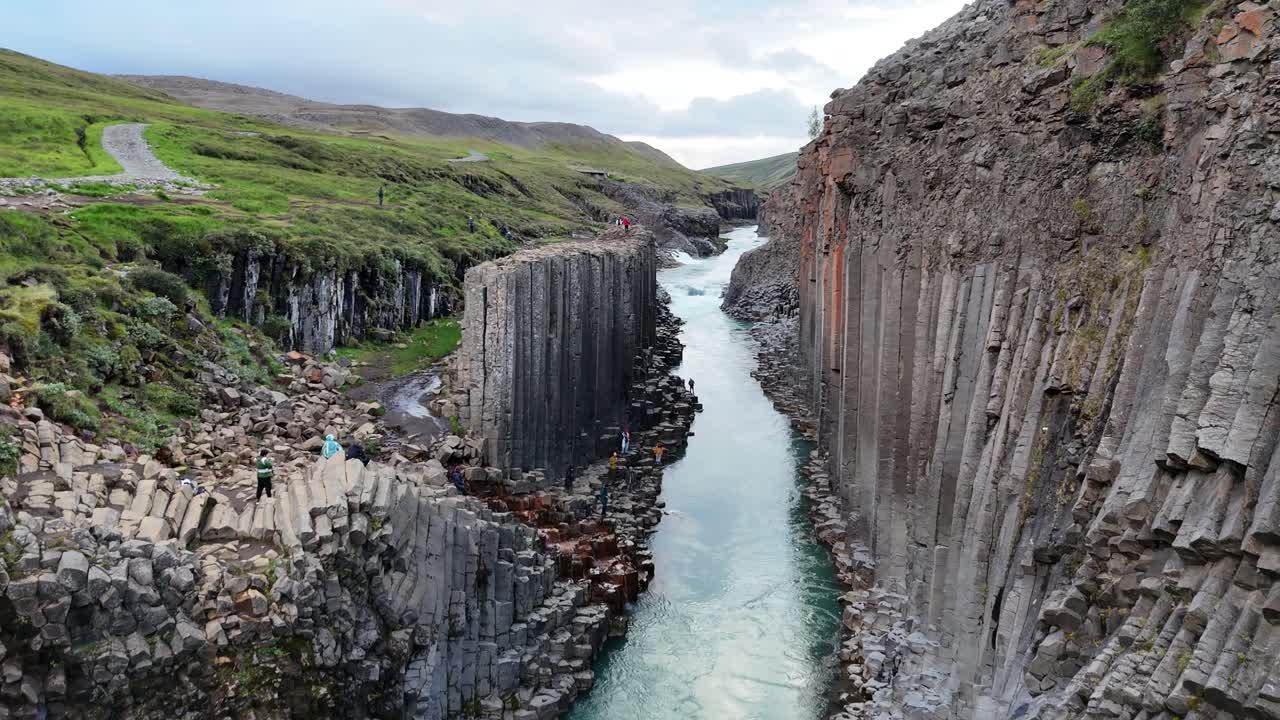 Basalt Cliffs and Blue River Cutting Through Studlagil Canyon in Iceland