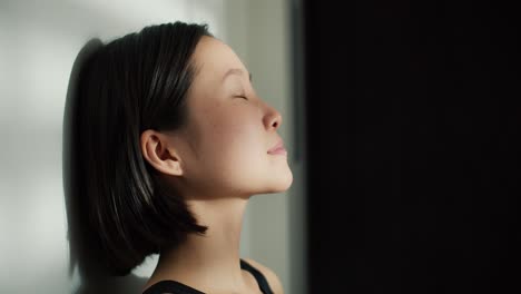 side portrait of a beautiful soft chinese woman laying on the floor with closed eyes