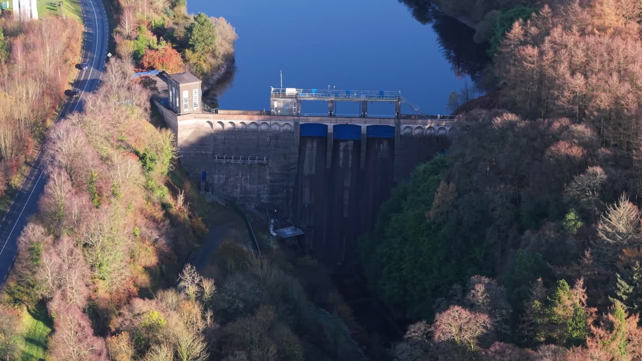 Poulaphouca hydro station and dam surrounded by autumn trees at Blessington Lake