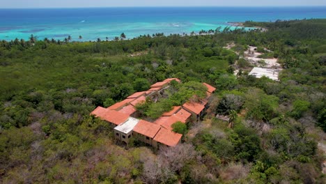 Overgrown-Tropical-Resort-on-coastline--Closed-after-hurricane-damage--aerial-pan