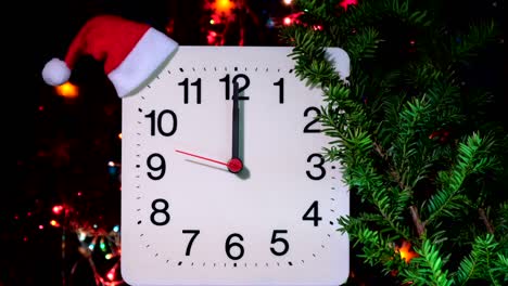 clock in branches of new year's fir on black background. second hand moves in circle of mechanical clock and show twelve o'clock at  midnight and eve of christmas. holiday concept, time lapse, closeup, close-up