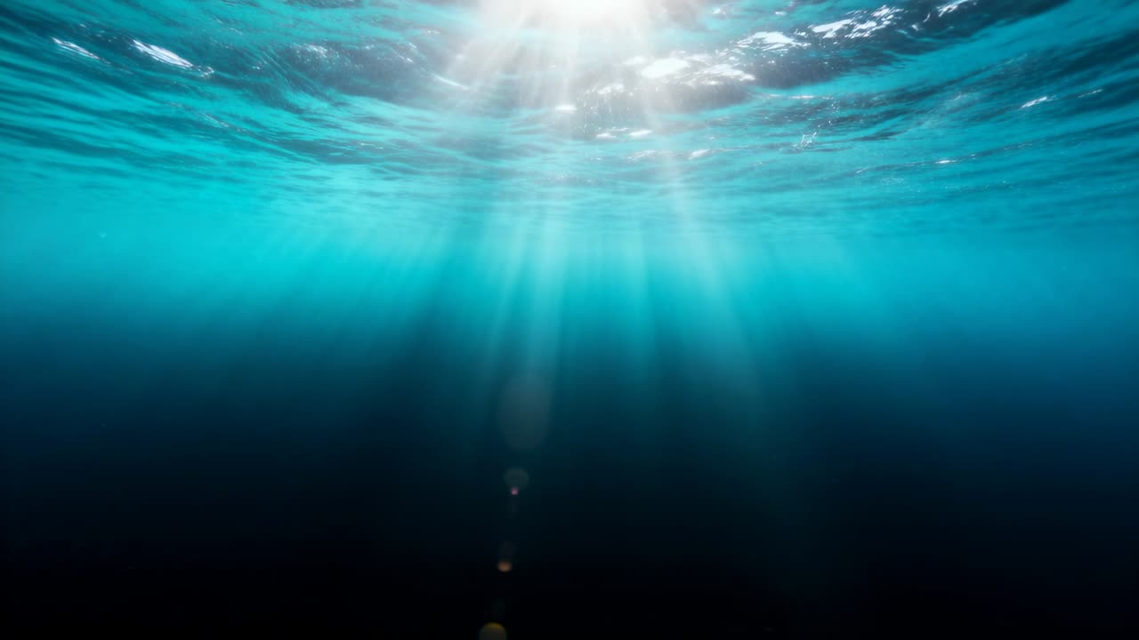 Vertical video: Surface ripples shifting, sun forming beams and lens flares for marine design