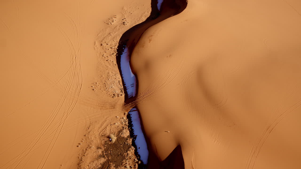 Drone shot from above highlighting the abstract shapes of the Pink Sand Dunes in Southern Utah.