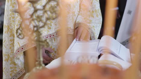 hands of orthodox priest searching through the bible