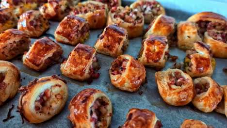 mini puff pastries filled with bacon and onion baked to golden perfection, closeup
