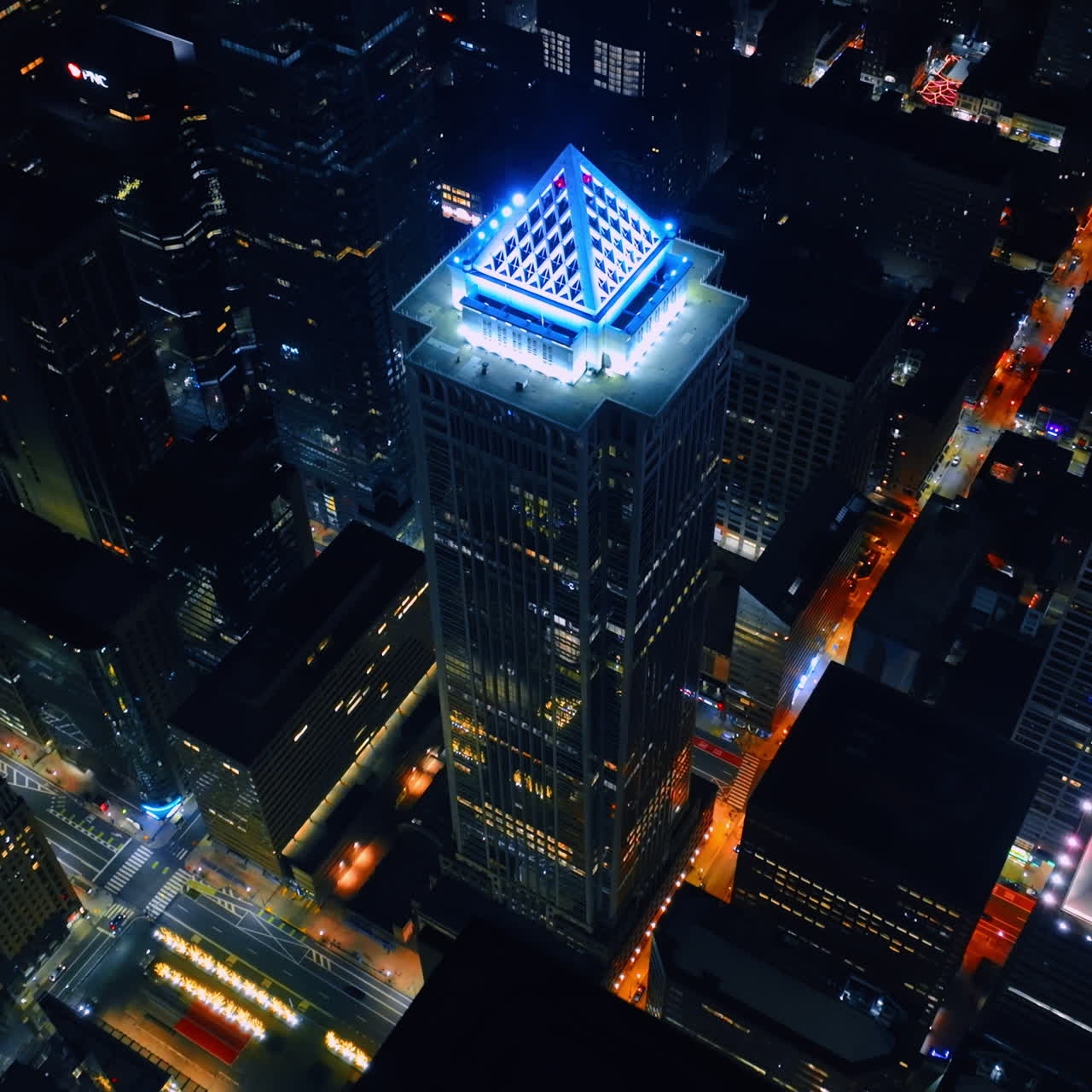 Highlighted top of BNY Mellon Center with white neon light. Distancing from the skyscraper of Philadelphia, Pennsylvania, USA at night.