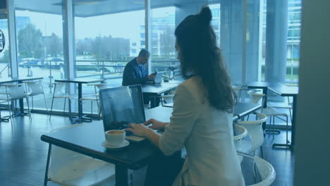 Animation-of-multicolored-graphs-over-biracial-woman-preparing-reports-on-laptop