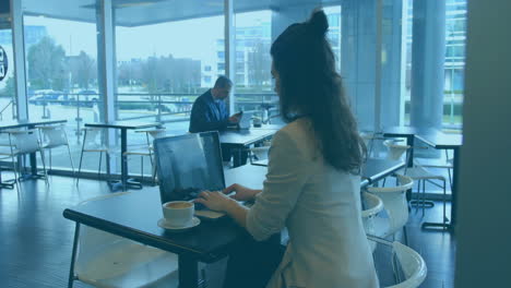 animation of multicolored graphs over biracial woman preparing reports on laptop