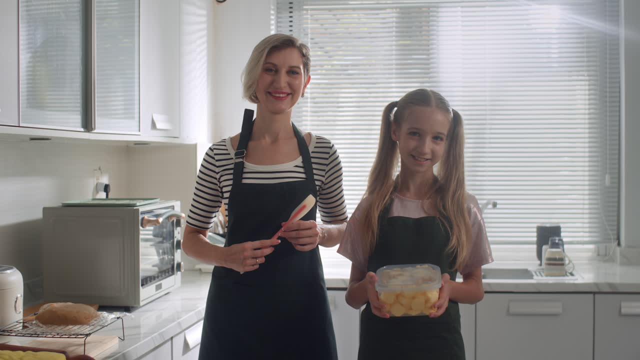 Caucasian Daughter and Mother Cooking Biscuits at Kitchen