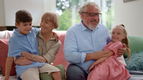 portrait of family talking together in living room