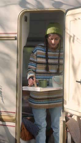 teenage girl serving food in camper van