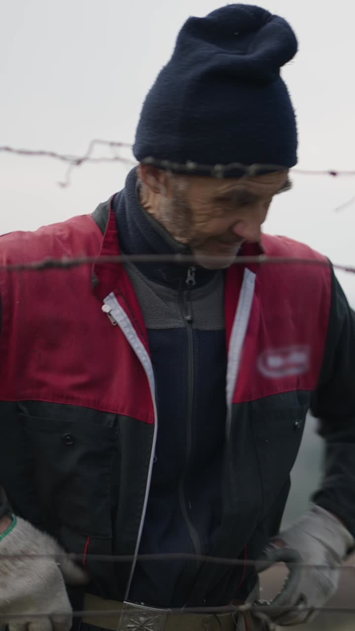 Man working with barbed wire