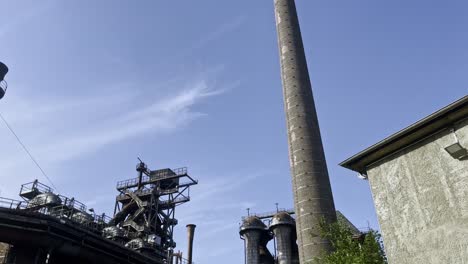 large historic stone of a steelworks in the landscape park duisburg north in germany overgrown by nature