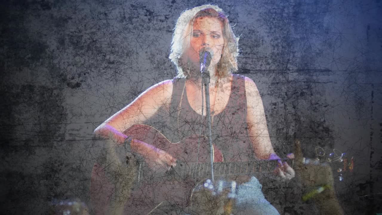 Singer starting with first guitar strum, singing into mic for crowd, cracked overlay obscuring face