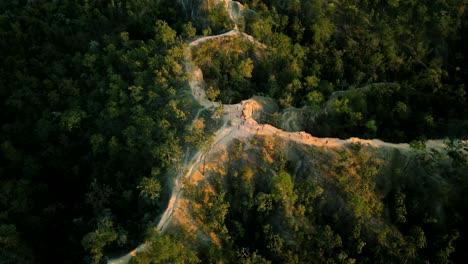 4k cinematic nature aerial drone footage of the beautiful mountains of mae hong son at the famous canyon next to pai, thailand during sunset