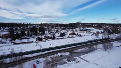 Train-passing-the-beautiful-small-town-Vikersund-in-Norway