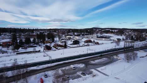 train passing the beautiful small town vikersund in norway