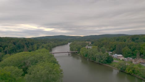 drone shot of the susquehanna river in nineveh passing a bridge