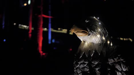 wooden sculpture eagle illuminated at night