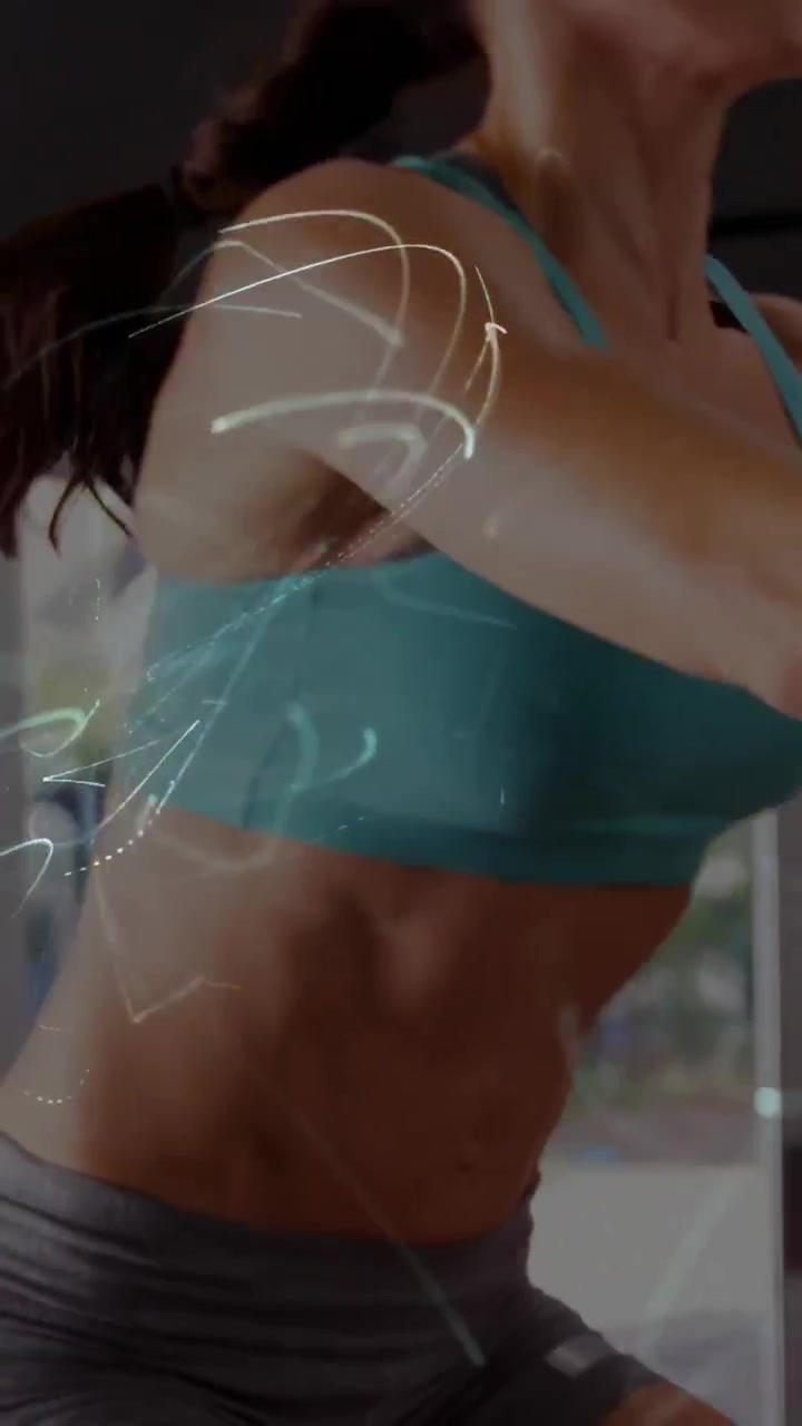 Vertical video: Woman entering right, boxing for fitness, light trail crossing frame then exiting
