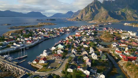 drone flight over henningsaer in the lofoten islands, revealing shot of the arctic village with beautiful backdrop